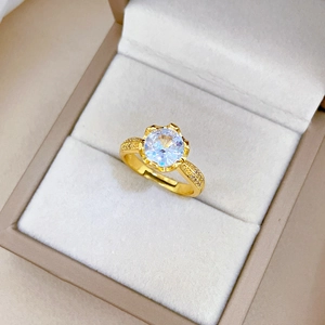 Close-up of gold-plated adjustable ring with zircon stones in a velvet jewelry box