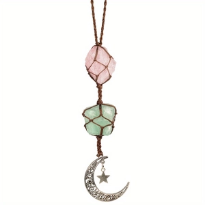 Detail of handmade woven amethyst pendant with raw stones and moon star charms