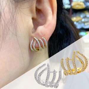 Detail of 18K gold-plated micro-pave zircon flame earrings on model and in studio