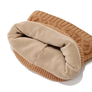Detail of warm winter neck warmer with caramel knit pattern and soft fleece lining