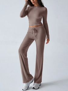 Detail view of brown Y2K tracksuit featuring drawstring waist pants and slim fit long sleeve crop top