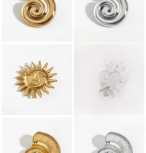 Polished stainless steel seashell and sun face brooches in gold and silver finishes