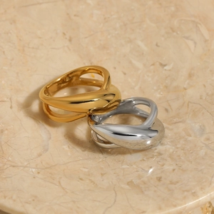 Modern gold and silver irregular crossover rings in polished stainless steel