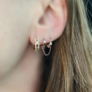 Close-up of S925 sterling silver gold hoop earrings with chain link and pave diamonds