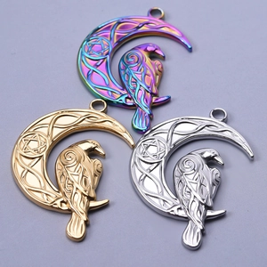 Macro shot of 304 stainless steel raven on crescent moon charms in gold, silver, and rainbow