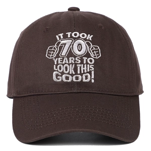 Detail of white embroidery on dark brown cotton cap with 70th birthday celebration text