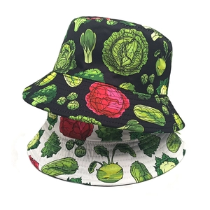 Black and white cotton bucket hats featuring vibrant all-over vegetable pattern prints