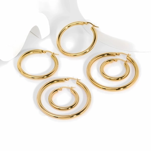 Three sizes of polished 18k gold stainless steel hoop earrings on a white artistic pedestal