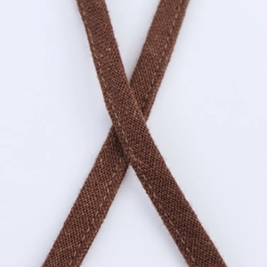 Detailed macro view of high-quality brown linen blend fabric straps with beaded texture