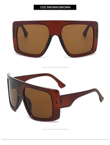 Detail view of oversized tortoise brown frame sunglasses with gradient tea lenses