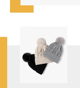 Detailed knit texture and fluffy pom poms of thick winter beanies in black, beige, and grey