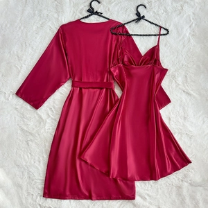 Elegant red silk satin pajama set with long robe and slip dress on white plush rug