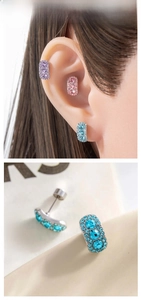 Macro shot of rectangular ear studs with blue zircon inlay and pave micro-diamonds