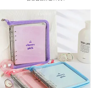 Detail of PVC cherry binder covers in purple, pink, and blue with smooth zipper closure