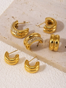 Detailed view of 18K gold plated double C-shaped stud earrings with inlaid crystals