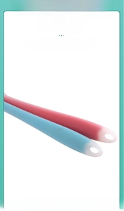 Detail of pink and blue silicone spatula handles with matte texture and hanging holes
