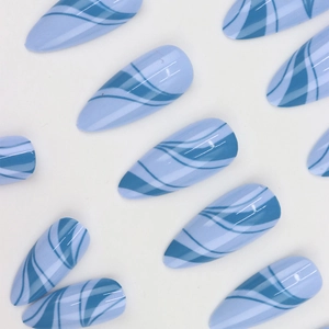 Elegant blue wave pattern press-on nails in glossy stiletto shape on white background