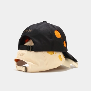 Modern two-tone baseball caps in black and beige with cutout details and adjustable metal buckle