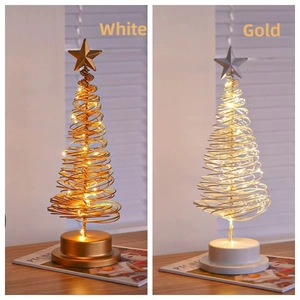 Detail of metal spiral Christmas tree lights in gold and white with LED star toppers
