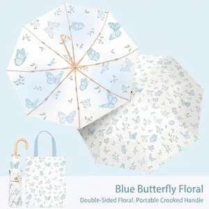 Detail of French vintage folding umbrella with double-sided floral print and hook handle