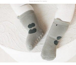 Detail of baby non-slip floor socks with cloud pattern and white anti-skid grip dots