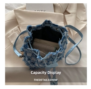 Top view of denim bucket bag with frayed checkerboard design showing large interior capacity