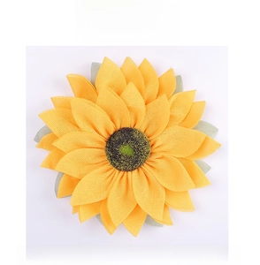 Macro view of sunflower fabric door decoration with yellow mesh petals and green leaf details
