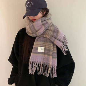 Maillard style purple and grey checkered scarf with tassels worn by a model in a studio