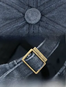 Detail of vintage baseball cap stitching and antique bronze metal adjustable buckle