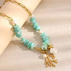 Detail of 18K gold-plated necklace featuring light blue stone, pearl and coral pendant