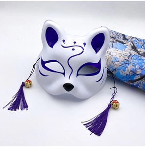 Close-up of Japanese fox mask with purple patterns, silk tassels and gold bells