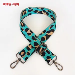 Close-up of emerald green leopard print nylon strap with gunmetal swivel hooks