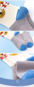 Close-up of knit texture and cute cartoon animal pattern on toddler cotton crew socks