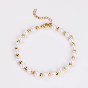 Detailed shot of vintage pearl bracelet with gold beads and lobster clasp on white background