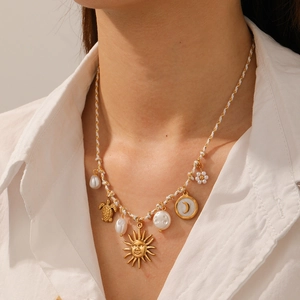 Handmade woven rope necklace with gold sun, sea turtle, moon and baroque pearl charms