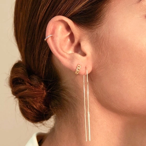Detail of S925 silver fringe earrings set with gold ear cuff and purple stone