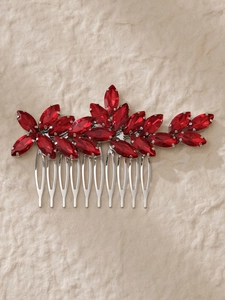 Detail of red marquise rhinestones on a silver hair comb with floral crystal patterns