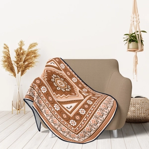 Detail of bohemian knit blanket with geometric patterns on a cozy sofa