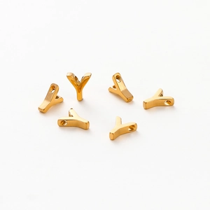 Close-up of polished gold-plated letter Y alphabet beads for DIY jewelry making
