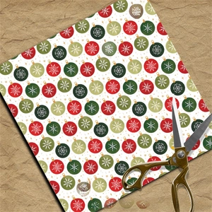 Detail of vintage Christmas scrapbook paper with festive ball ornaments and gold scissors