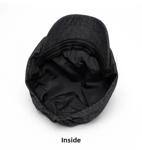 Detailed interior view of dark grey denim newsboy cap featuring black lining and sweatband