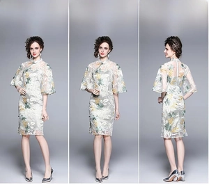 Detail of floral embroidery on retro cheongsam dress with stand collar and handmade buttons