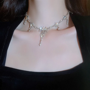 Close-up of sparkling silver tassel necklace with rhinestones on a female model