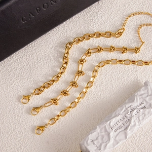 Close-up of three 18k gold plated stainless steel chains with lobster clasps