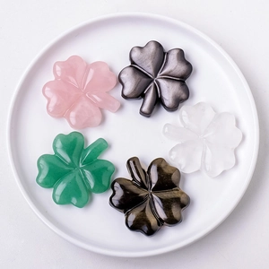 Hand-polished natural crystal four-leaf clover carvings in five colors on a ceramic tray