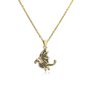 Detailed view of a gold plated hip hop dragon pendant with black cubic zirconia stones