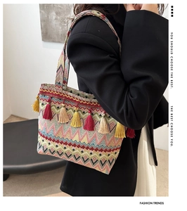Detail of bohemian tote bag with colorful geometric patterns and decorative tassels