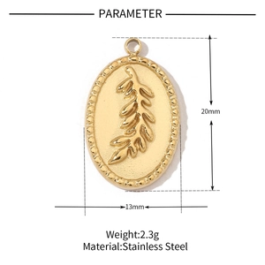 Detailed macro view of an oval stainless steel pendant with leaf pattern and dimensions