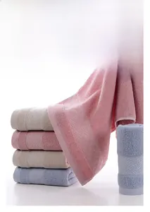Detail of soft cotton towels showing floral jacquard edges and thick woven texture