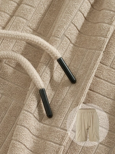 Macro detail of men's casual shorts with waffle texture and drawstring waist belt